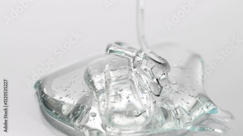 Transparent serum, gel drips on the table. Cosmetic bag transparent texture macro.