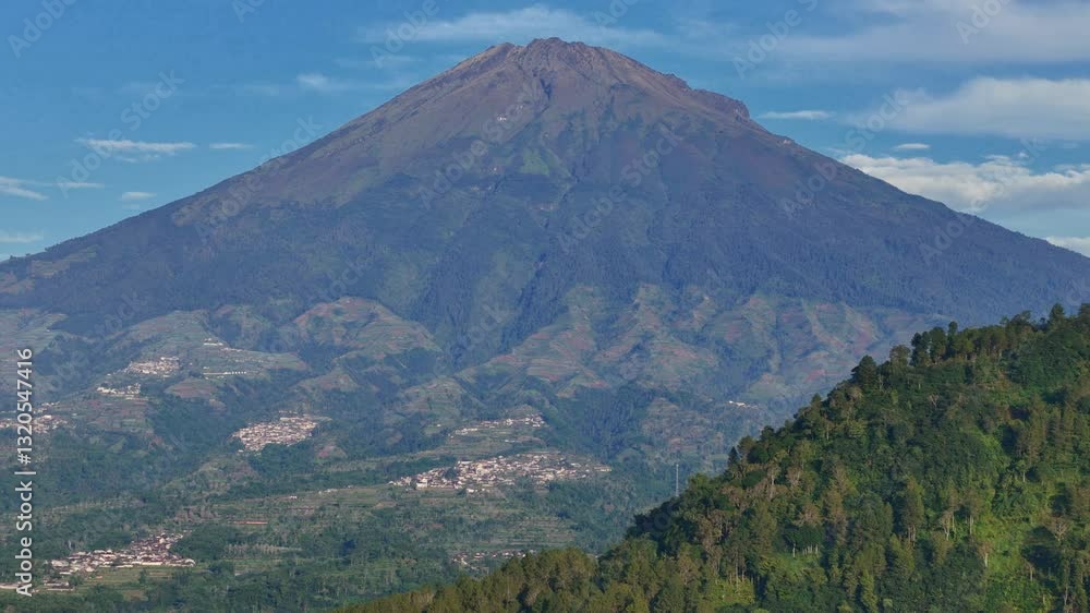 Aerial view of Mount Sumbing with forestry hills on foreground. Aerial view of Mount Sumbing with forestry hills on foreground.