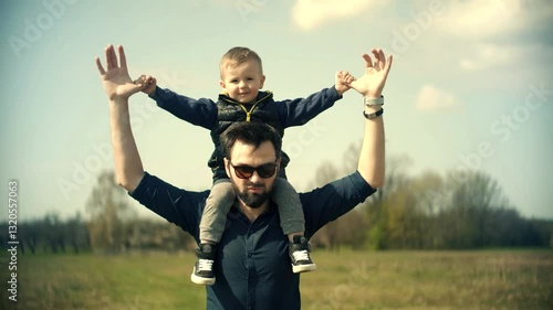 Wallpaper Mural The son is sitting on his father's shoulders outdoors . Clear sunny day Torontodigital.ca