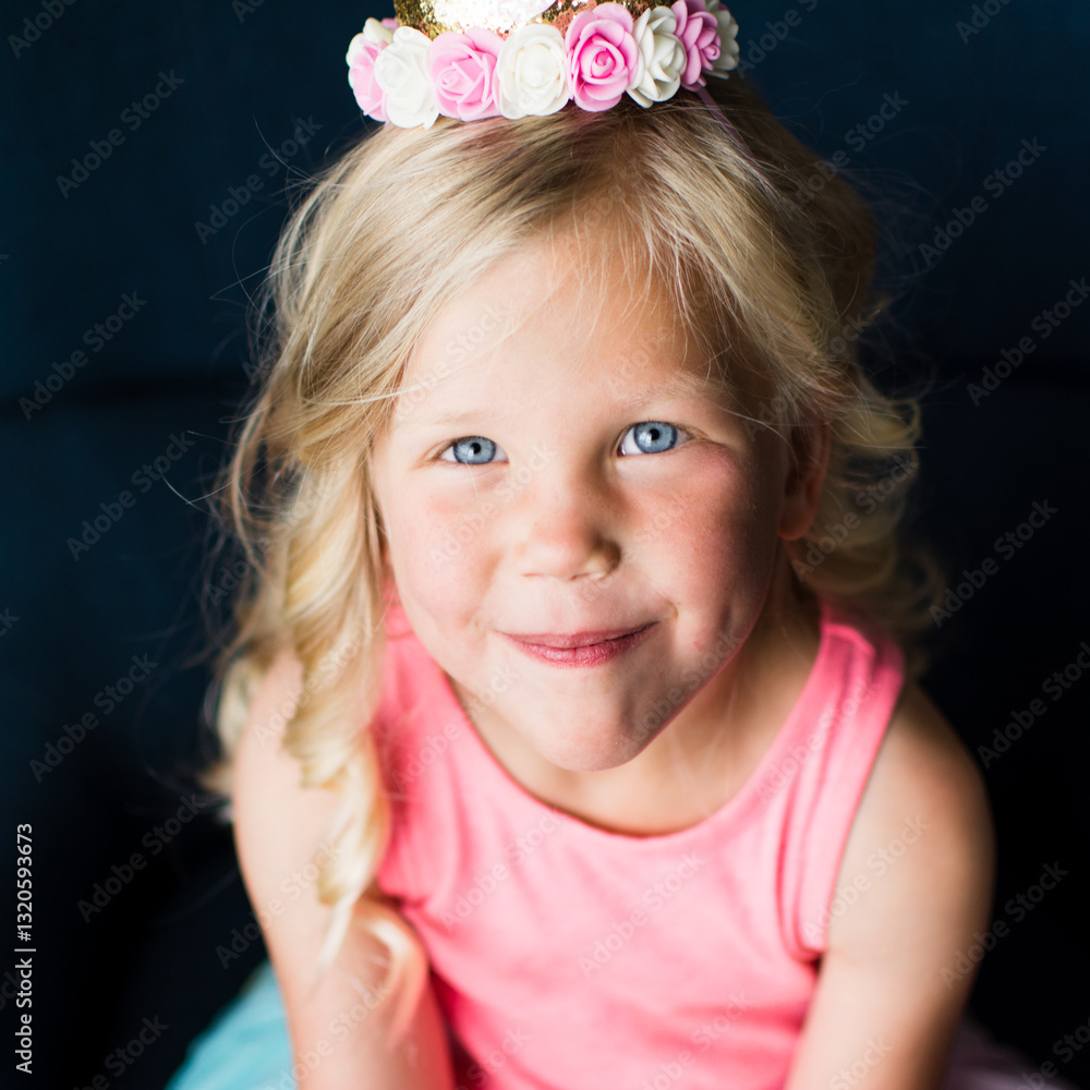 Close-up of smiling young girl wearing rainbow dress and floral crown Close-up of smiling young girl wearing rainbow dress and floral crown