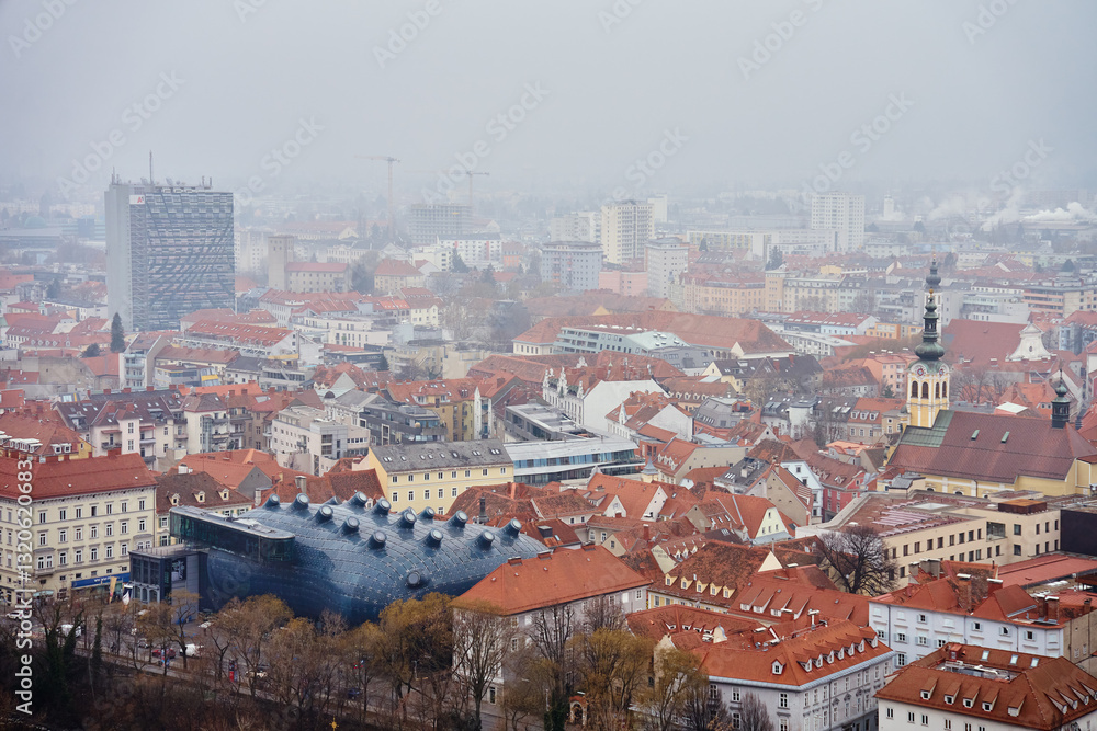 Graz cityscape on foggy day. Panoramic view of Graz, Austria with historical architecture. Streets with red roofed buildings in European city