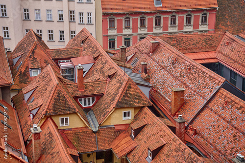 Obraz na płótnie Scenic aerial view of historic European rooftops covered with red clay tiles and chimneys. Old town architecture and traditional cityscapes in European city. Panoramic view of Graz, Austria w salonie