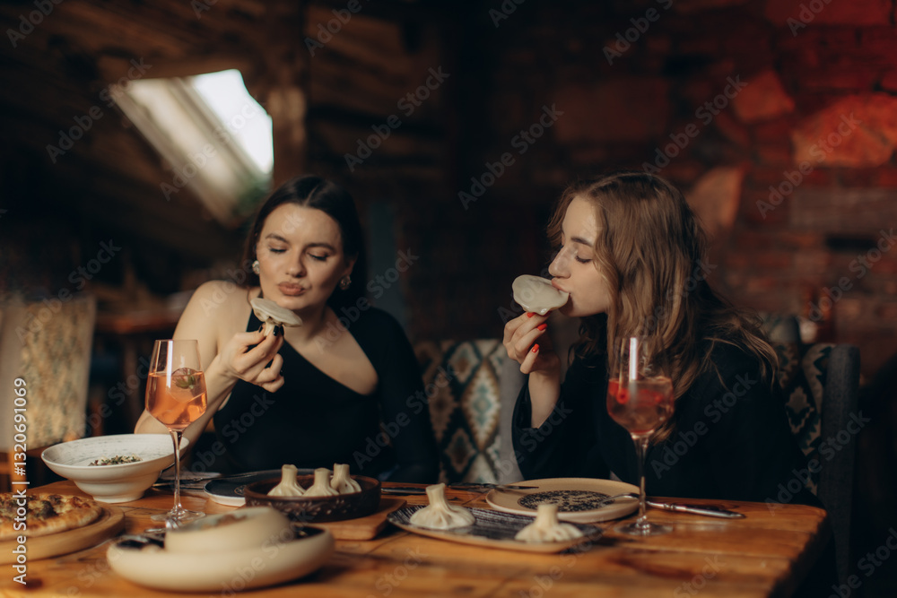 Two Women Enjoying Dumplings and Drinks in a Cozy Restaurant Setting Two Women Enjoying Dumplings and Drinks in a Cozy Restaurant Setting