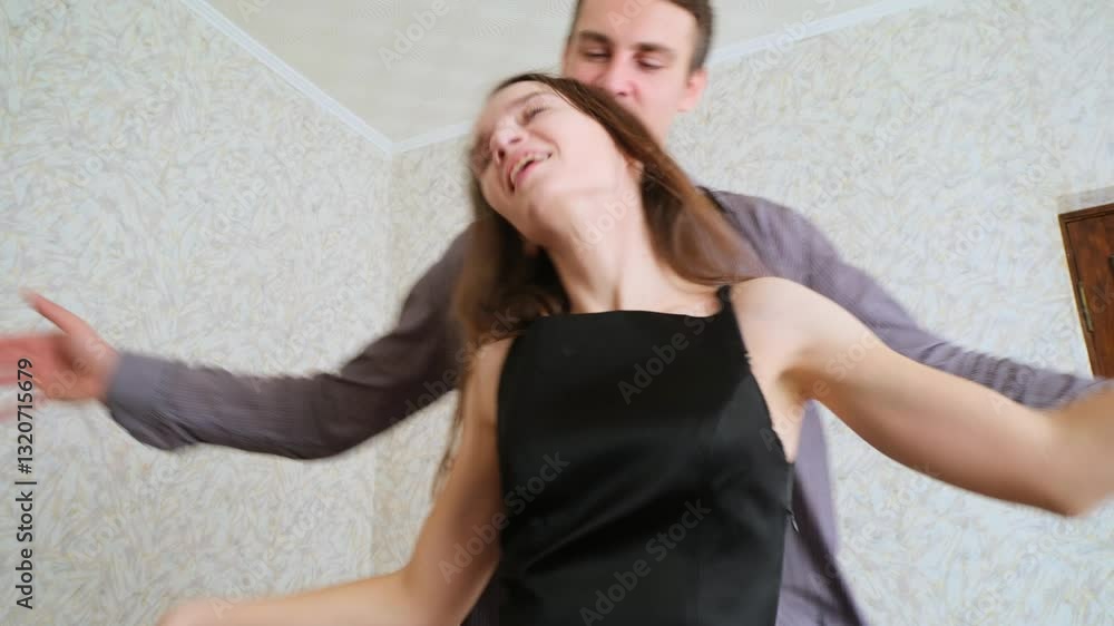 Loving couple in dresses dancing together at home Loving couple in dresses dancing together at home