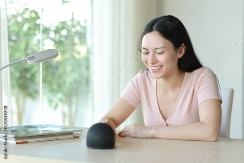 Free Download Happy asian woman starting smart speaker - GFXLoad