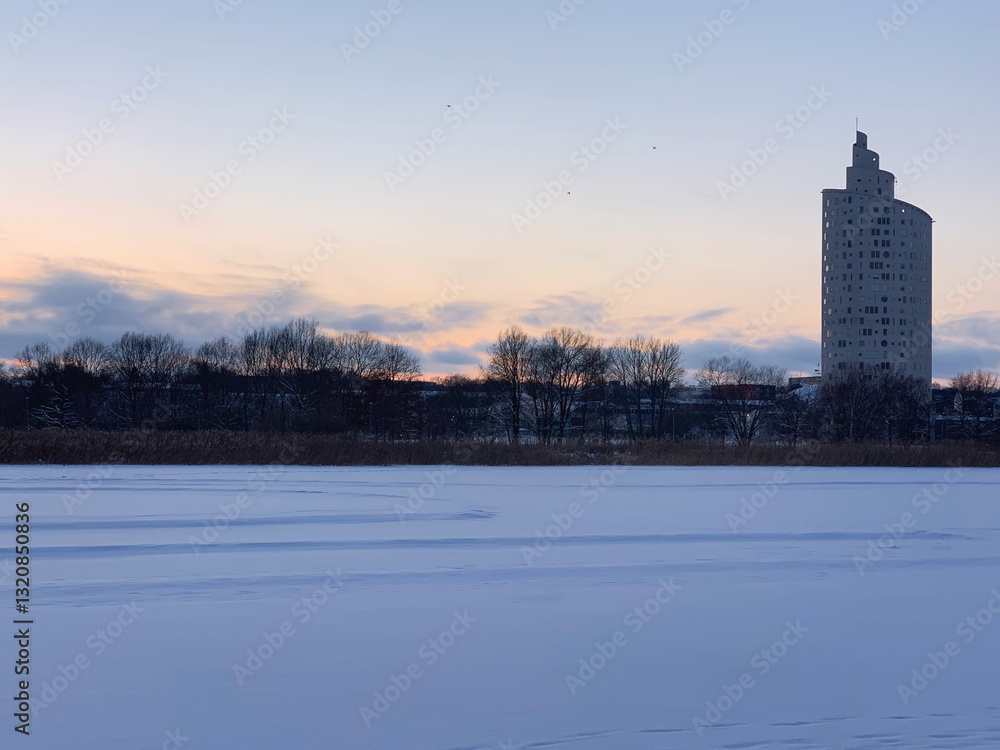 Winter sunset over the Anne lake and Tigutorn building in the city Tartu, Tartumaa, Estonia, February 2021 Winter sunset over the Anne lake and Tigutorn building in the city Tartu, Tartumaa, Estonia, February 2021