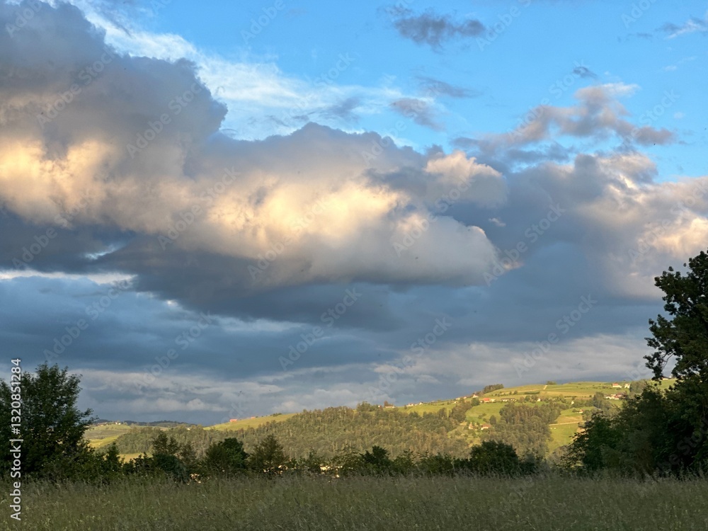Countryside landscape with the mountains and the clouds during sunset near Zug, Switzerland, May 2024