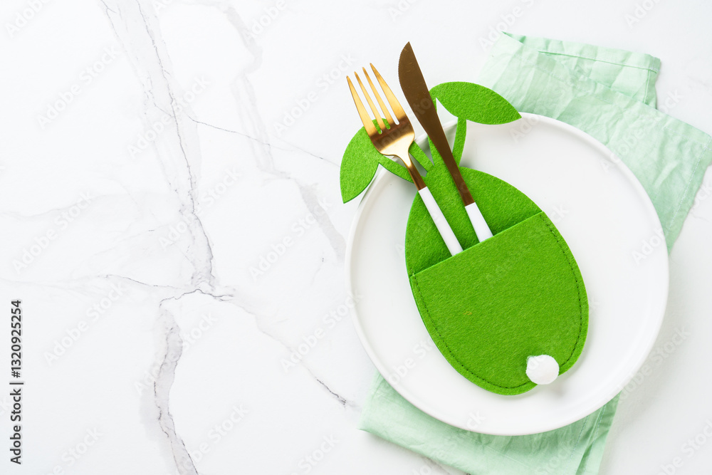 Easter table setting with cute decorations at white background.