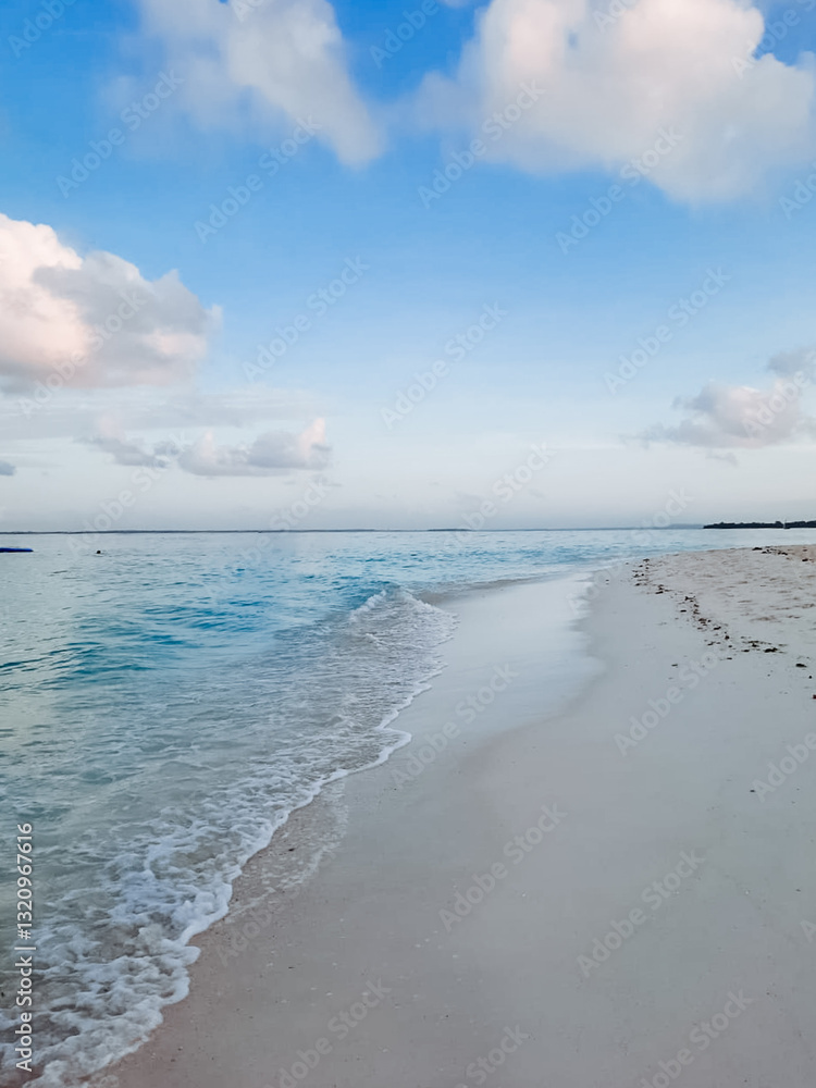 Imagine a stunningly beautiful beach where gentle waves gracefully roll onto the golden sand, beneath a wide open blue sky decorated with fluffy white clouds scattered throughout Imagine a stunningly beautiful beach where gentle waves gracefully roll onto the golden sand, beneath a wide open blue sky decorated with fluffy white clouds scattered throughout