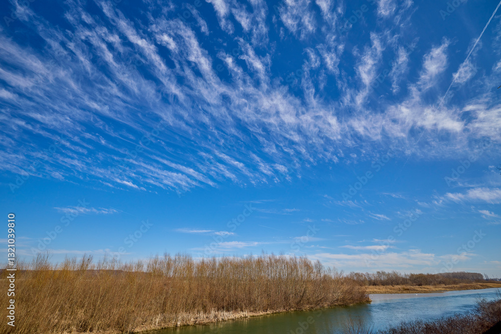 landscape with a river and blue sky with clouds landscape with a river and blue sky with clouds
