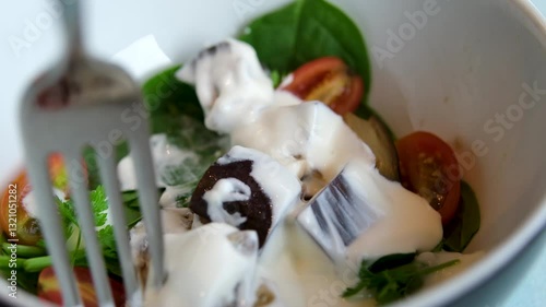 Eggplant Salad Baked pieces of eggplants with pepper in tomato sauce in large metal pan on table. Indian vegetarian and heathy food 