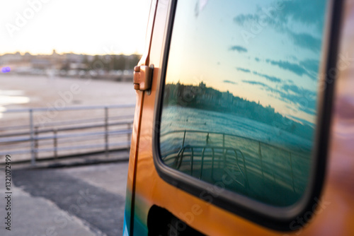 Ocean and sky reflection from van window at Bondi Beach photo