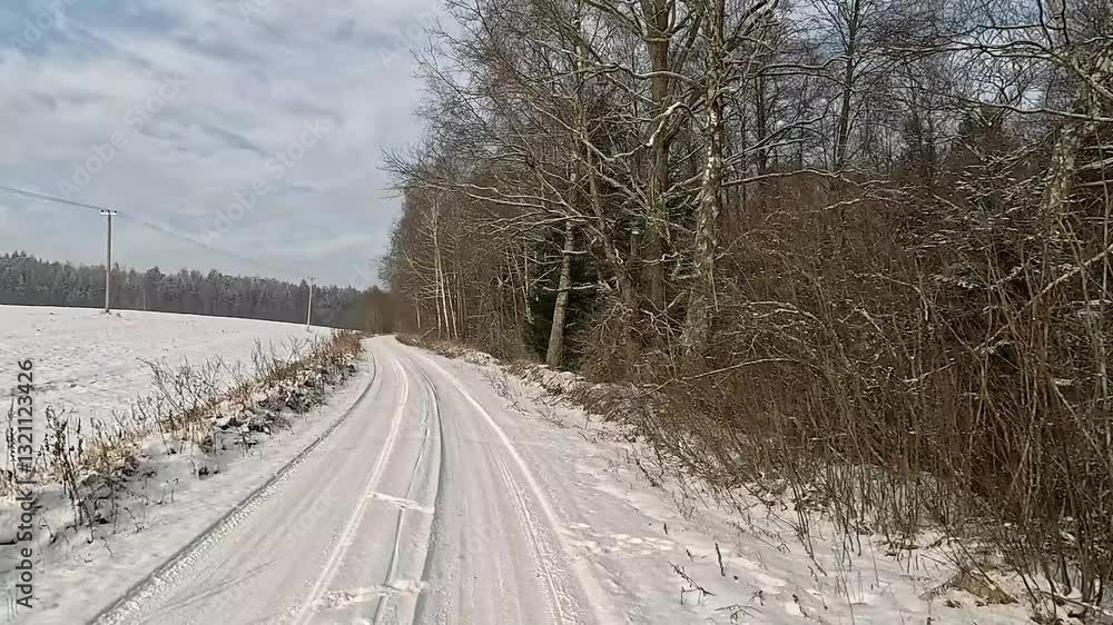 Winter road with snow, highway with cars on a sunny winter day. Winter landscape, road and shoulder covered with snow. Winter road with snow, highway with cars on a sunny winter day. Winter landscape, road and shoulder covered with snow.