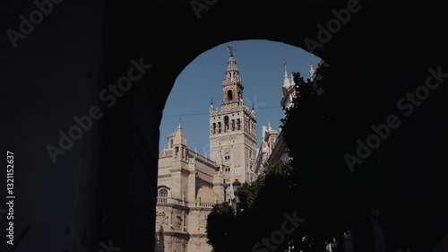 A picturesque view of the Giralda, the Cathedral, and orange trees, showcasing Seville’s architectural beauty