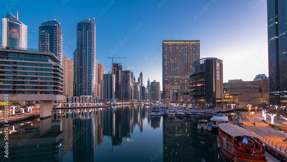 Obraz premium Dubai Marina towers and canal in Dubai night to day timelapse
