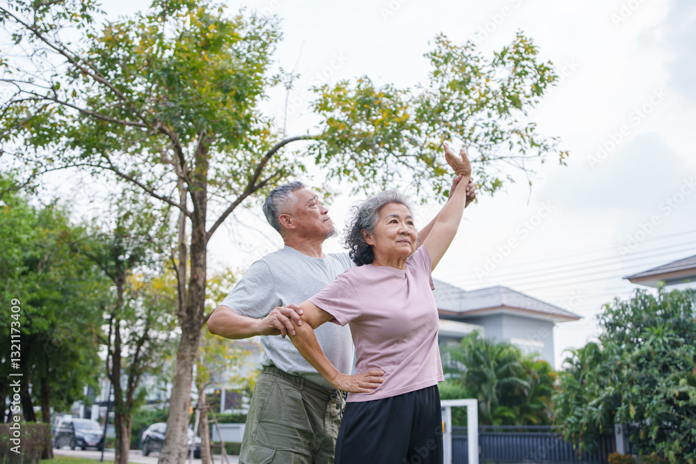 Obraz premium Asian senior couple practices stretching in a park, enjoying each other and exercise.
