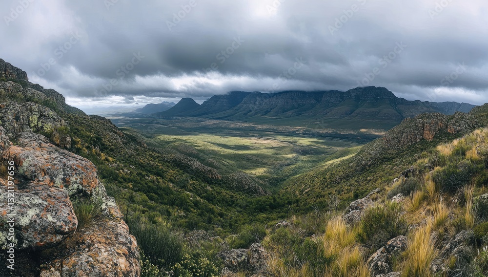Naklejka premium Mountain valley vista under a dramatic sky