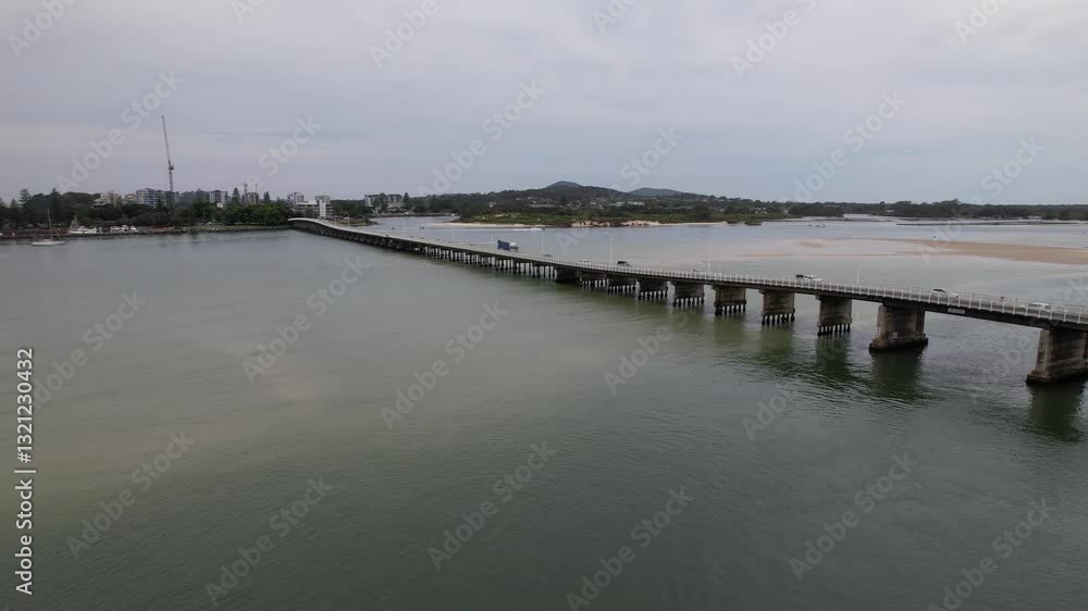 Vehicles Driving On Head Street Bridge Crossing Coolongolook River In Forster, New South Wales, Australia. wide drone shot Vehicles Driving On Head Street Bridge Crossing Coolongolook River In Forster, New South Wales, Australia. wide drone shot