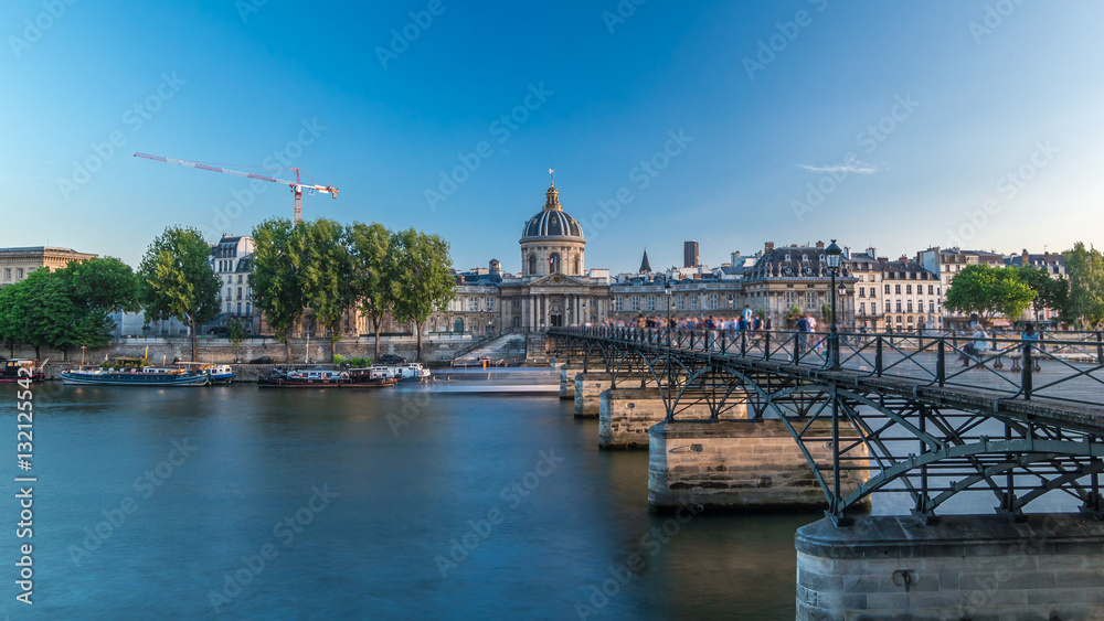 Naklejka premium People walk on the Bridge of Arts over the River Seine to the Institute of France timelapse hyperlapse - Paris, France