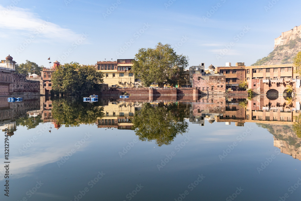 Fototapeta premium pristine calm lake with water reflection of vintage architecture around at morning