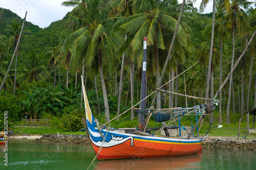 Karimunjawa island, Jepara regency, Central Java, Indonesia - June 11, 2017: A colourful traditional small fishing boats moored in a tropical island