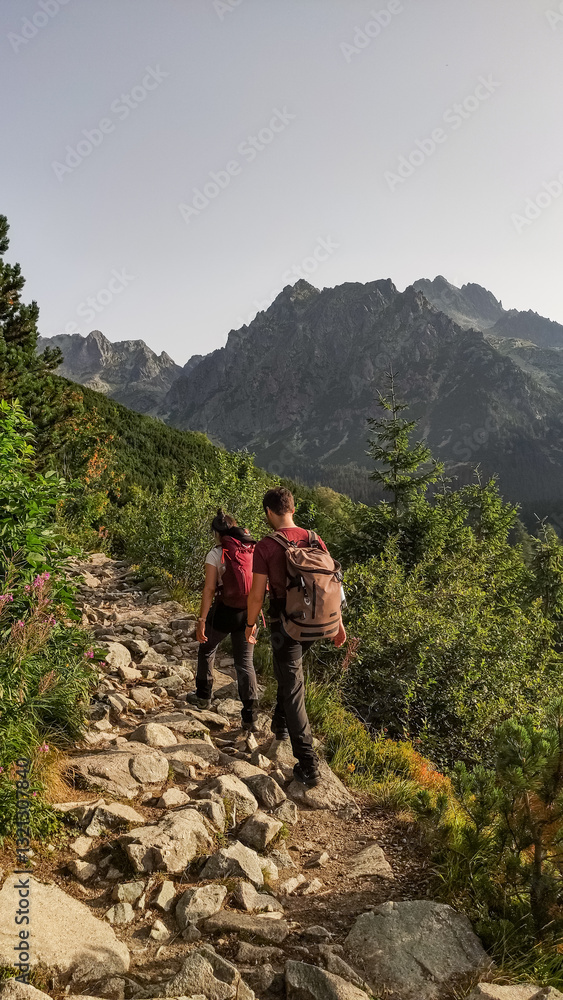 Hikers walking on rocky path in high tatras mountains Hikers walking on rocky path in high tatras mountains