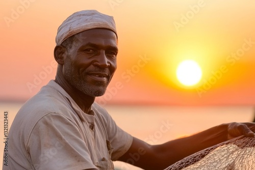 Fisherman smiling at sunset with nets by the water in a calm coastal village photo