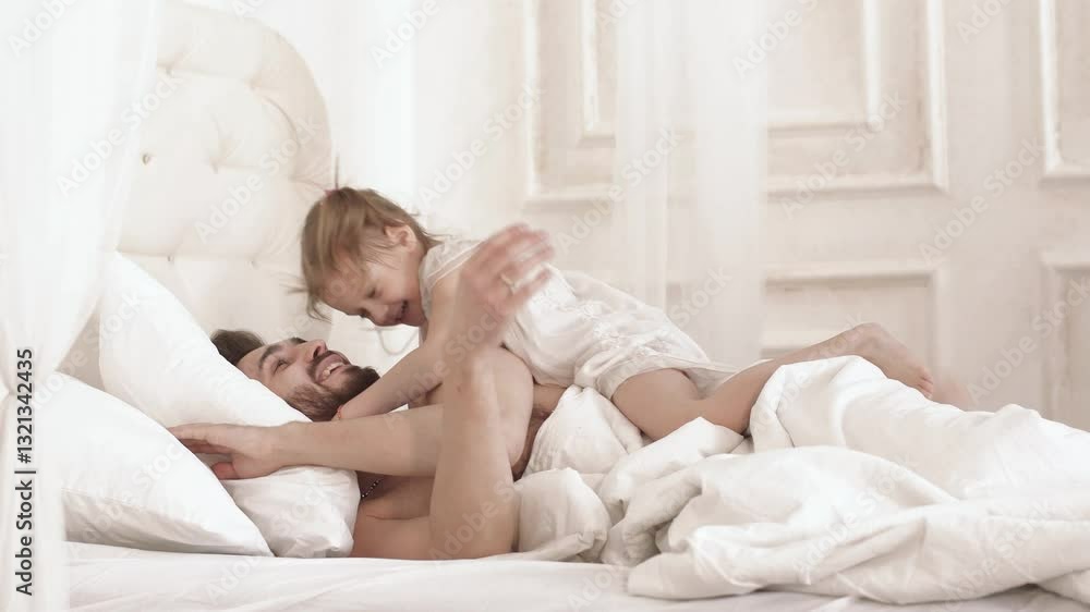 Little daughter wakes up dad in bed Little daughter wakes up dad in bed