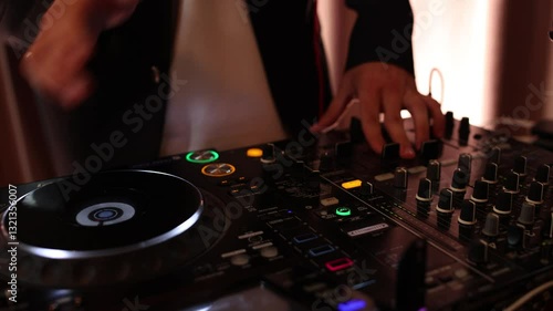 DJ playing music on the console at a disco