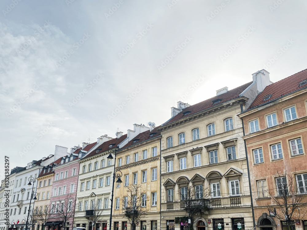 Obraz premium Historic architecture and street scene in Warsaw, Poland with people strolling