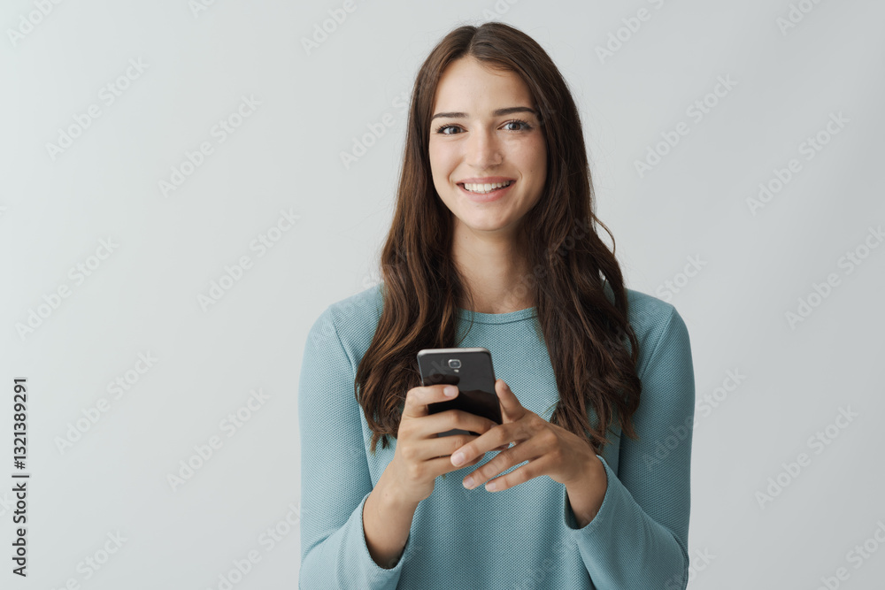 Beautiful young woman holding a smartphone Beautiful young woman holding a smartphone
