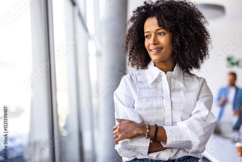 Confident Businesswoman Standing in Modern Office with Bright Natural Lighting
