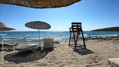 beach with umbrella and chairs