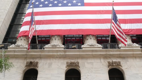 New York City, United States. Lower Manhattan Downtown Financial District urban architecture. Huge big American flag. Wall street Stock Exchange building, USA Stock Market trading.