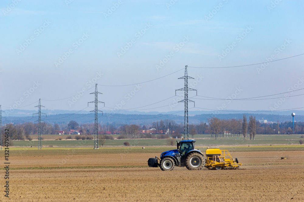 Tractor in a field of the early spring time agricultural activities.