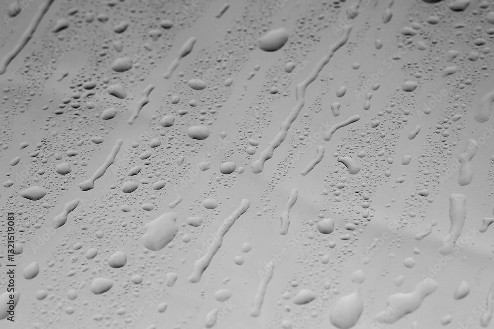Water drops on grey glass surface, closeup Water drops on grey glass surface, closeup