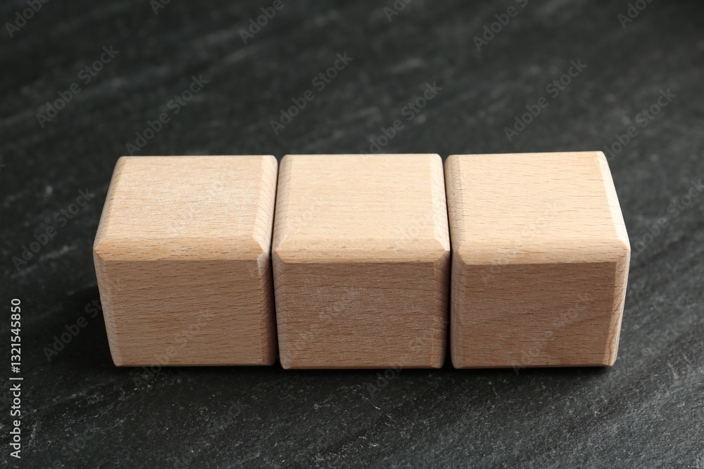 Blank wooden cubes on dark textured table, closeup Blank wooden cubes on dark textured table, closeup