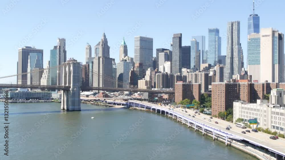 Brooklyn Bridge from Manhattan Bridge. New York City downtown skyline, financial district cityscape, World Trade Center. Transport traffic on FDR Drive highway by East River water, United States. Brooklyn Bridge from Manhattan Bridge. New York City downtown skyline, financial district cityscape, World Trade Center. Transport traffic on FDR Drive highway by East River water, United States.