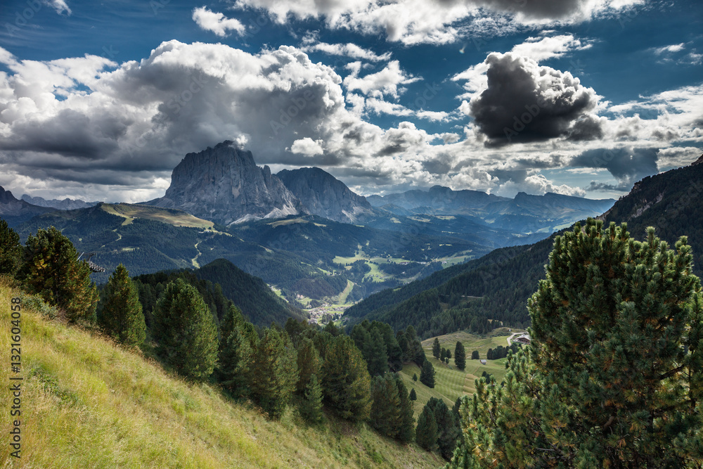 Naklejka premium Majestic views of Dolomites landscape near Seceda showcasing dramatic clouds and lush green valleys