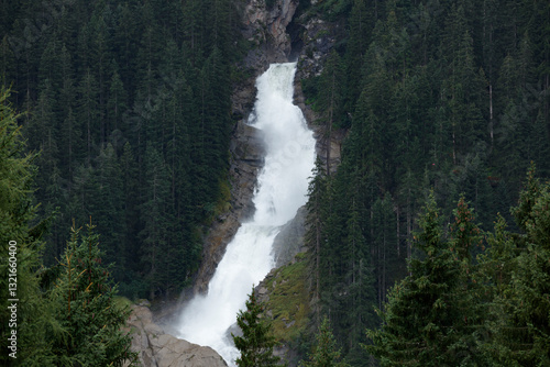 Majestic Krimml Waterfall cascades through lush forests in Austria, showcasing nature's power and beauty in a serene environment