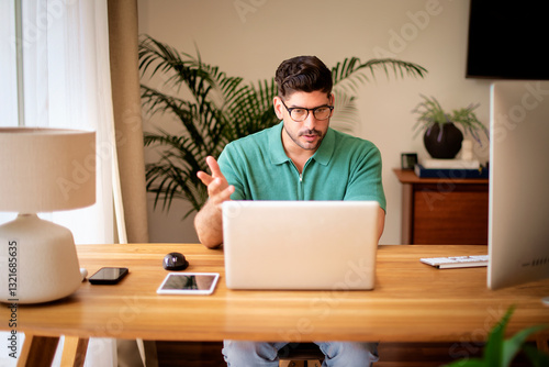 Wallpaper Mural Mid aged man sitting at desk at home and using his laptop Torontodigital.ca