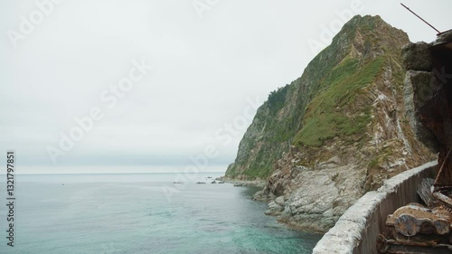 Sakhalin, Aniva lighthouse. Water, mountains and birds all around. Cloudy weather
