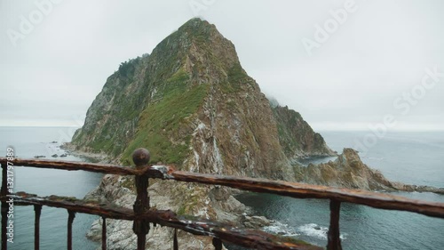 Sakhalin, Aniva lighthouse. Water, mountains and birds all around. Cloudy weather