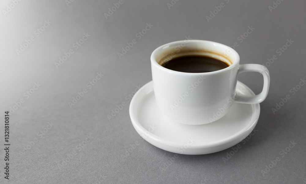 White cup of espresso on grey background with copy space. White cup of espresso on grey background with copy space.
