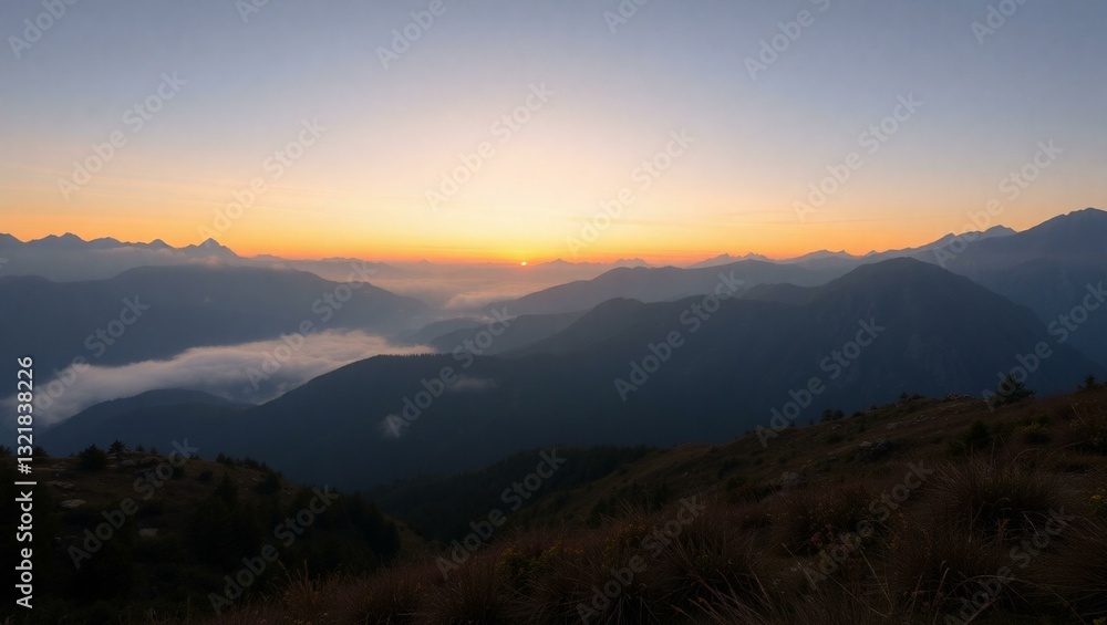 A stock photo of a breathtaking misty mountain range at dawn. A stock photo of a breathtaking misty mountain range at dawn.