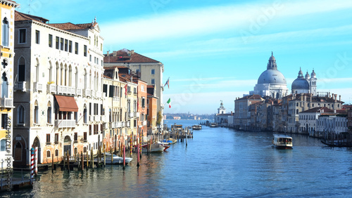 Picturesque view of the Grand Canal in Venice with historic architecture and boats under a clear sky
