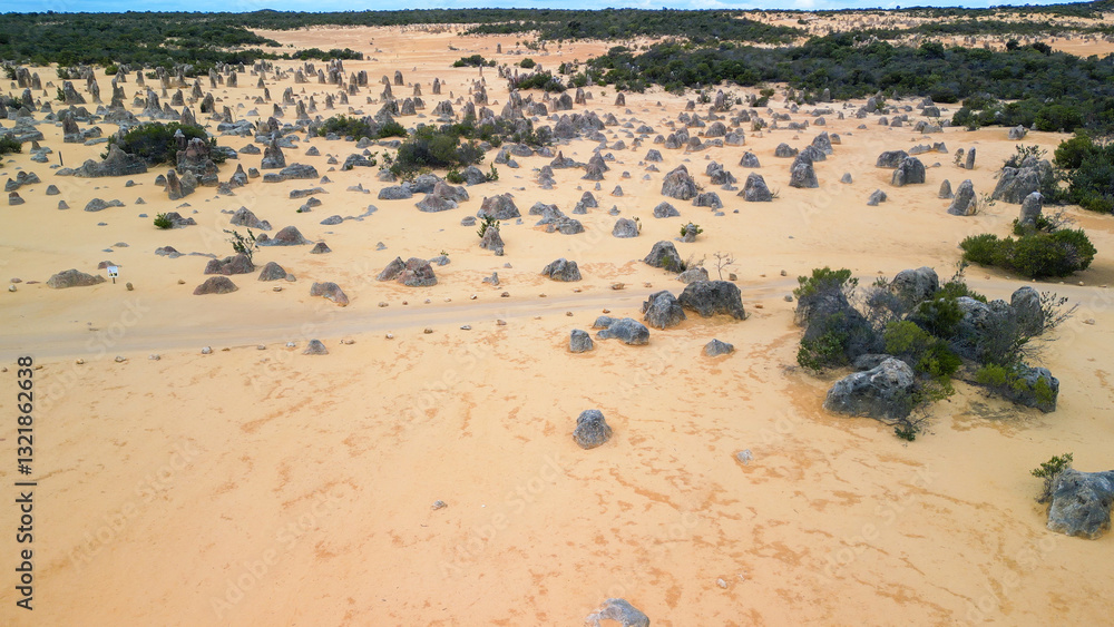 Breathtaking aerial shot of the Pinnacles Desert with golden hues at sunset, Western Australia