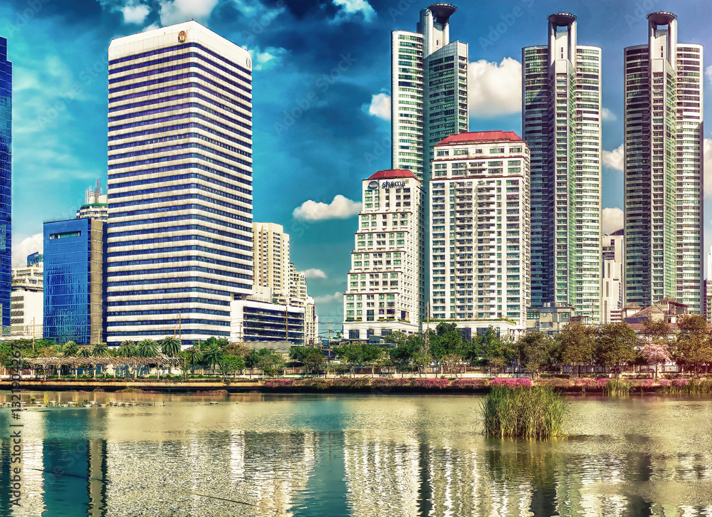 BANGKOK, THAILAND - DECEMBER 16, 2019: City skyline on a beautiful day from the famous Benjakitti Park. Panoramic view