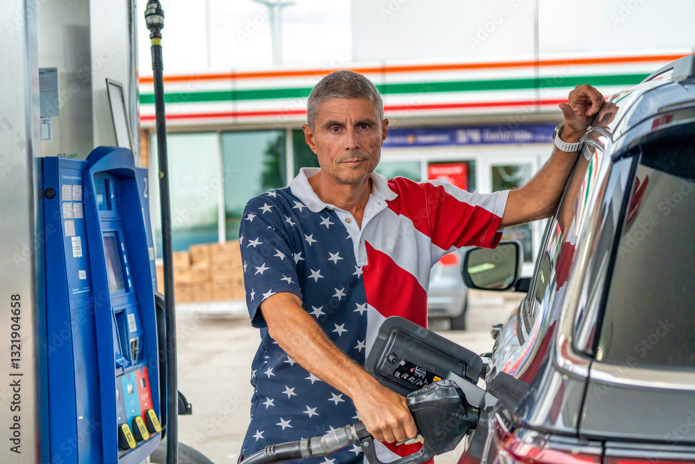 Refueling a vehicle at a petrol station with fuel nozzle in hand