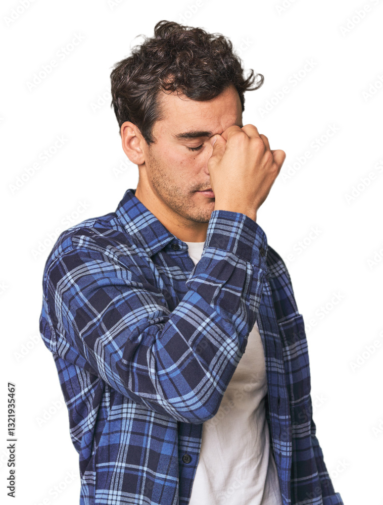 Young Hispanic man in studio having a head ache, touching front of the face. Young Hispanic man in studio having a head ache, touching front of the face.